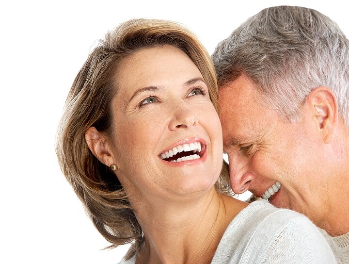 man in dental office after tooth replacement treatment with a dental crown